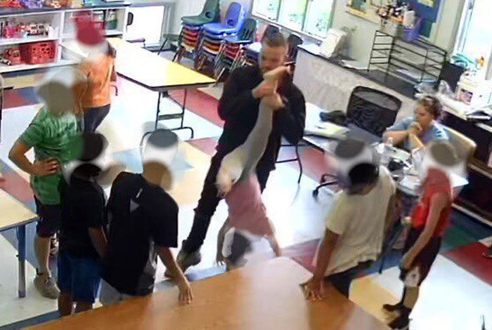 Day care worker picks child up by one leg